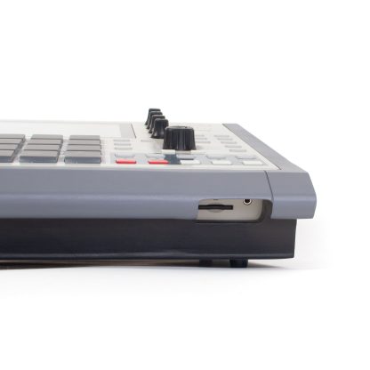 Detail of retro mpc one stand with open port hole for sd card and trs headphone jack access.